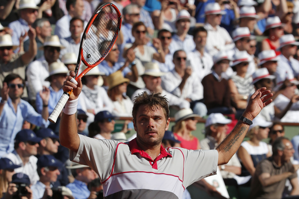 Switzerland’s Stan Wawrinka celebrates winning the men’s final of the French Open in four sets, 4-6, 6-4, 6-3, 6-4, against Serbia’s Novak Djokovic at the Roland Garros stadium, in Paris, France, on Sunday