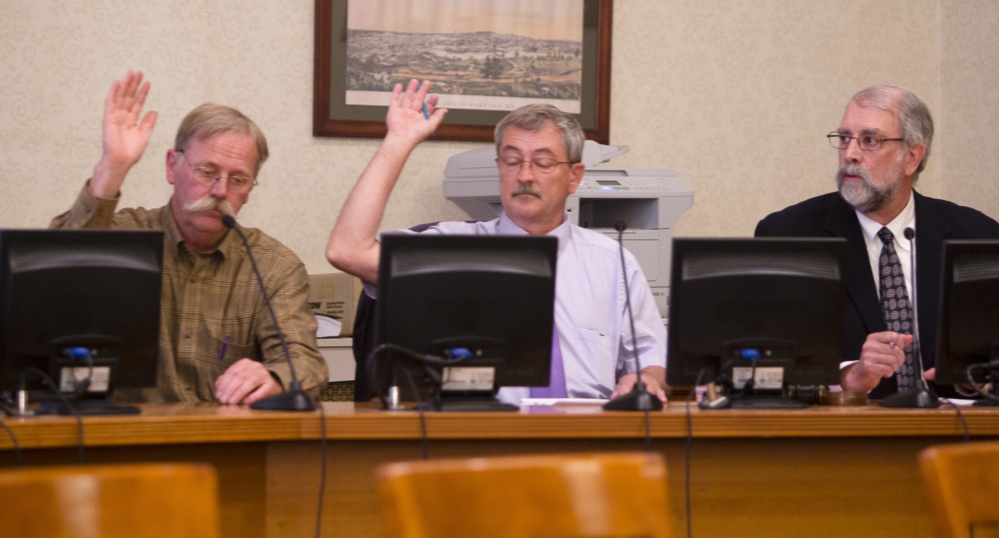 Members of the Biddeford City Council, including Councilor Michael Swanton and Council President John McCurry, vote to adjourn to executive session Monday, as Mayor Alan Casavant tallies the result. The council discussed whether Police Chief Roger Beaupre and Deputy Police Chief JoAnne Fisk should be suspended pending an investigation of sexual abuse allegations.