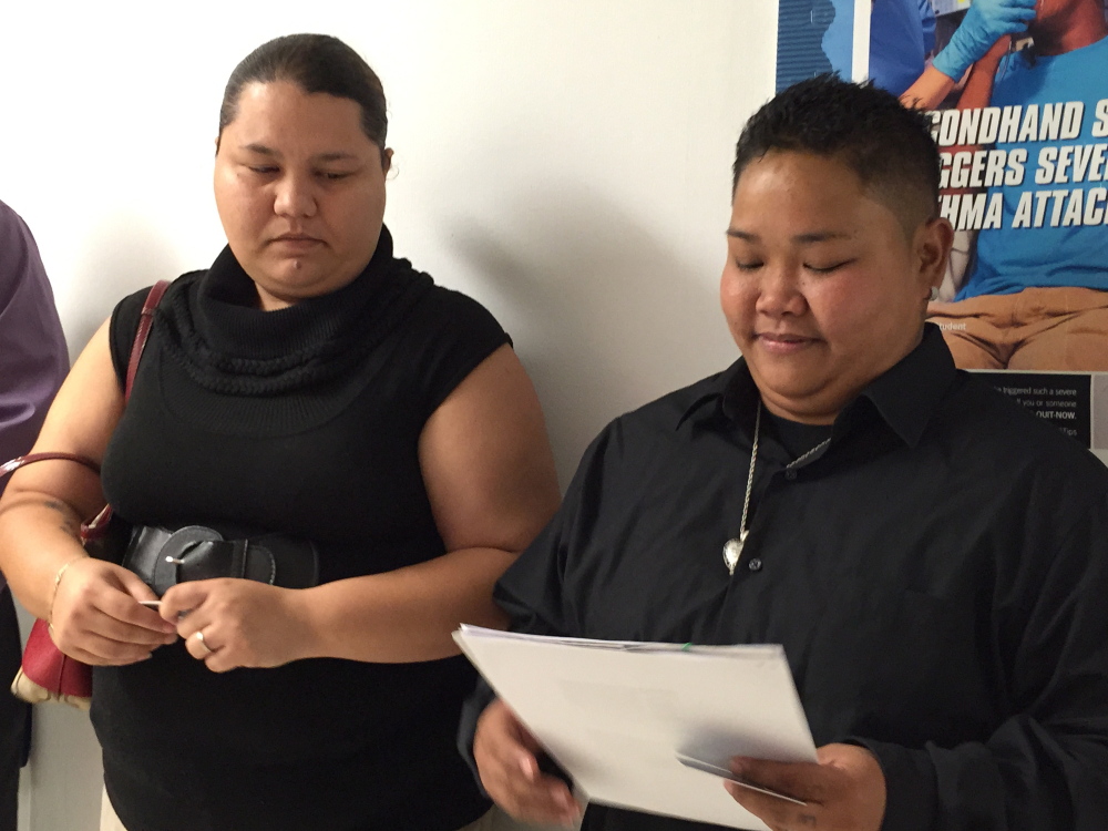 Loretta M. Pangelinan, right, holds the application for a marriage license that she and her fiancee, Kathleen M. Aguero, turned in at the Office of Vital Statistics in Guam.