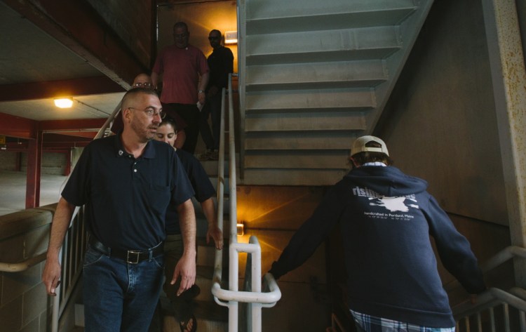 Dennis Welch, president of Local 110 of the National Correctional Employees Union, walks down the stairs of the parking garage across from the Cumberland County courthouse along with other jail employees Monday on their way to the county commissioners' meeting. Welch said the union will wait a week for the county to respond to its concerns about proposed contract changes before taking action, which might involve picketing at the jail.
