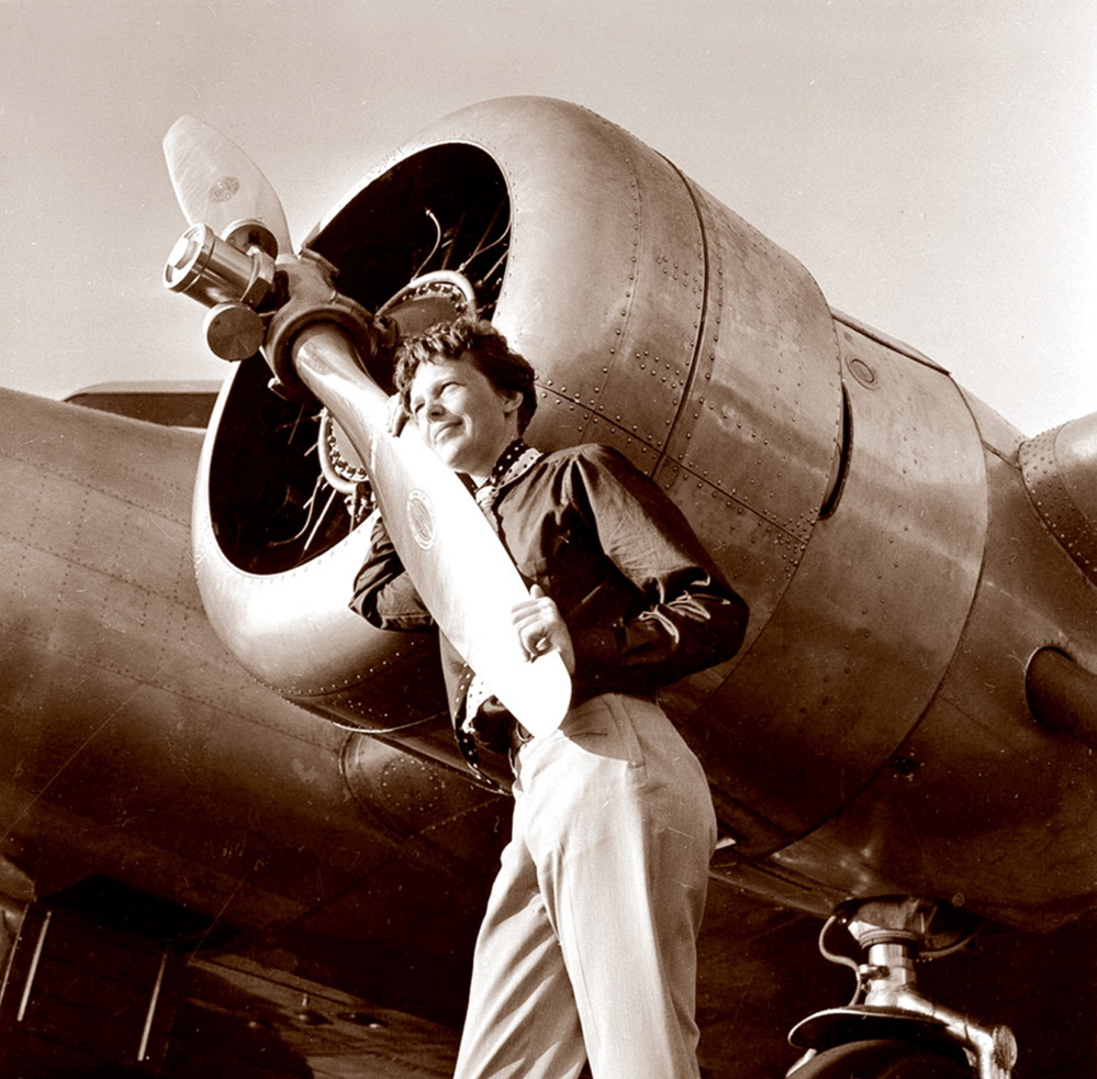 In this May 20, 1937 photo, aviator Amelia Earhart poses next to her Electra plane’s propeller. The photo was taken by Albert Bresnik at Burbank Airport in Burbank, Calif. It was a clear spring day in 1937 when Earhart, ready to make history by flying around the world, brought her personal photographer to the airport to document the journey’s beginning.