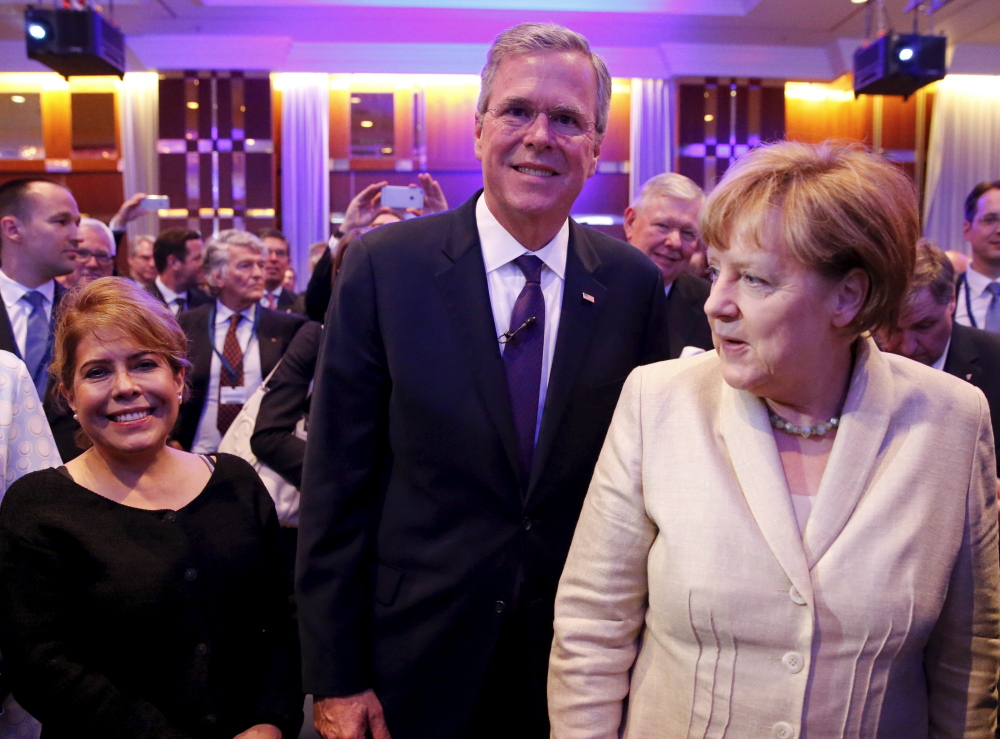 Jeb Bush with his wife Columba, left, and German Chancellor Angela Merkel attend the Christian Democratic Union economic council in Berlin Tuesday.