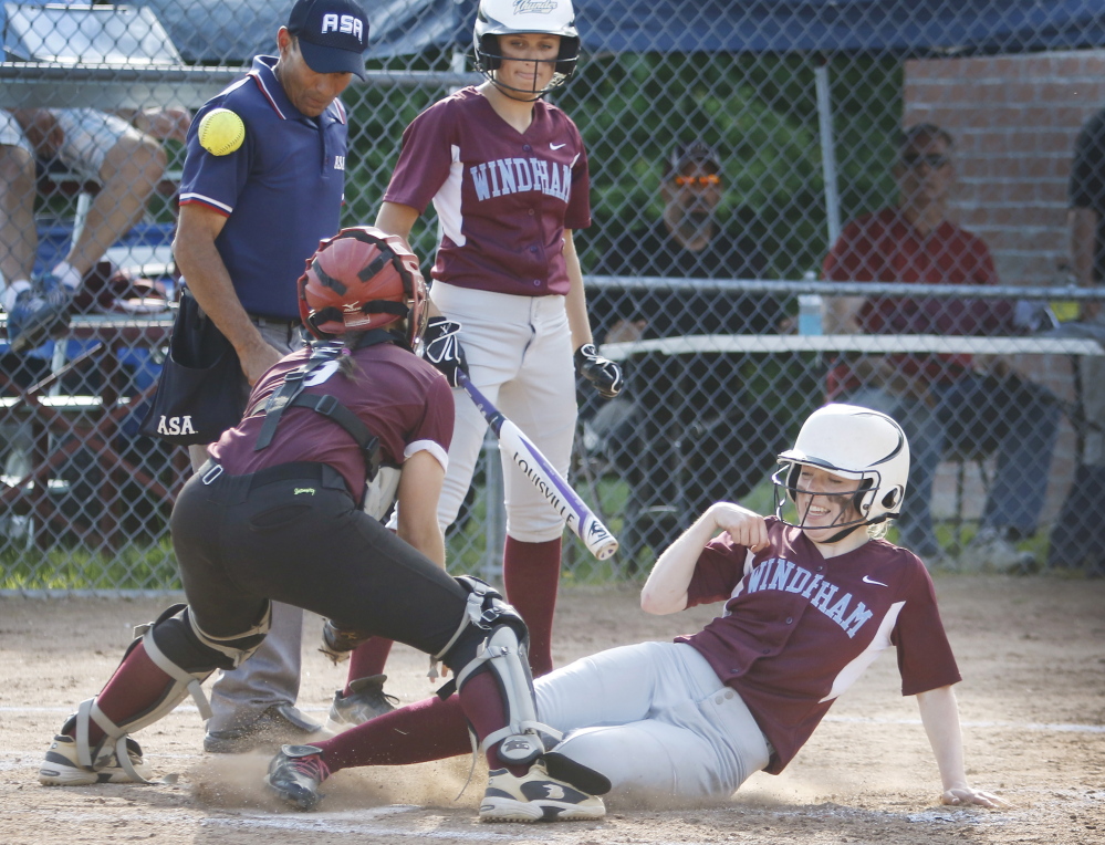 June 9: Windham batter Lauren Talbot watches as Katie Hunter slides into home to score as Gorham catcher Noelle Dibiase just misses the throw in the sixth inning at Windham Tuesday.
Jill Brady/Staff Photographer