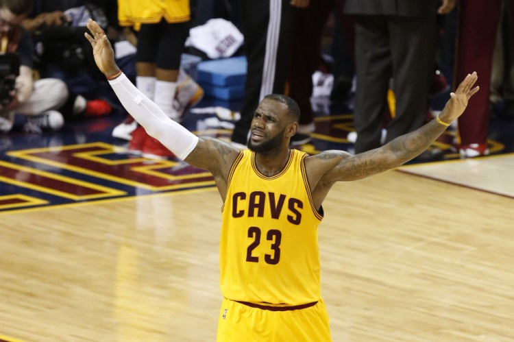 LeBron James spurs on the Cleveland crowd during the second half of Game 3 of the NBA Finals on Tuesday night. James led the Cavaliers with 40 points and put his team within two wins of the championship.