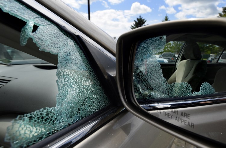A car parked at the park-and-ride on Marginal Way in Portland on Wednesday has a broken window. There has been a string of recent car burglries in Portland, but overall, the increase over last year is slight.