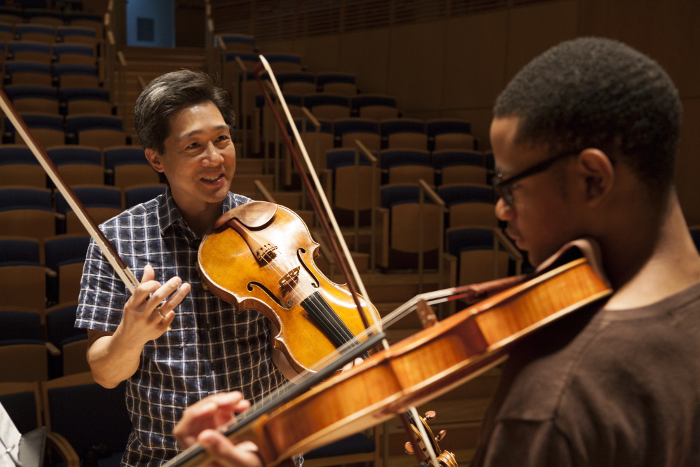 Co-artistic director Phillip Ying works with a student at the Bowdoin International Music Festival.