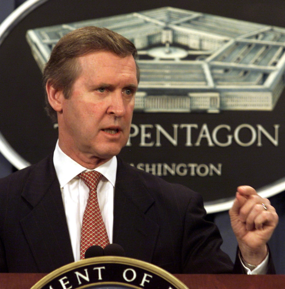 Secretary of Defense William Cohen answers questions during a news conference in 2001. Above right, Cohen as a member of the Bowdoin College basketball team. He saw himself solidly in the “jock” category until he was forced to write a sonnet and discovered a love of writing.