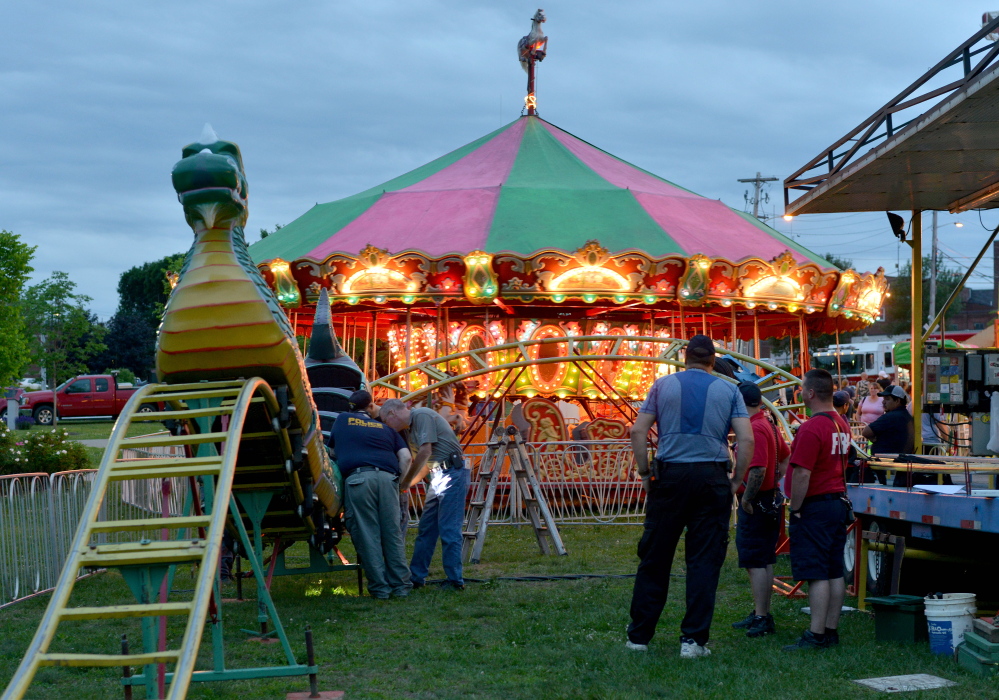 Inspectors from the Office of the State Fire Marshal investigate a ride malfunction Friday in Waterville.