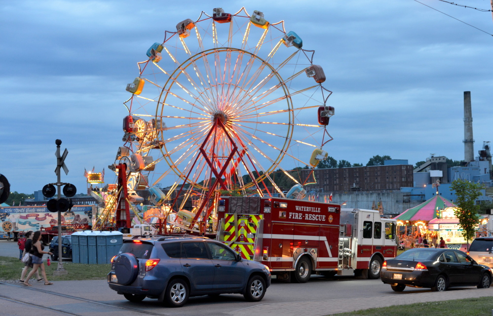 Inspectors from the Office of the State Fire Marshal investigate a ride malfunction Friday in Waterville.