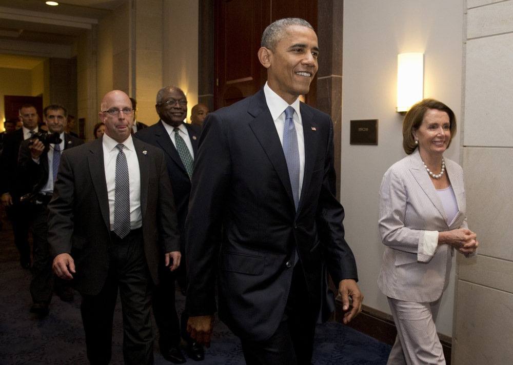 President Barack Obama walks with House Minority Leader Nancy Pelosi and House Minority Assistant Leader James Clyburn on Friday, on their way to a meeting with House Democrats on Capitol Hill. The president was making an 11th-hour appeal to drum up support for his trade agenda.