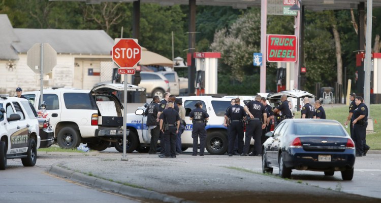 Police block the intersection of Dowdy Ferry Road and Interstate 45 during a standoff with a gunman barricaded inside a van Saturday in Hutchins, Texas. The gunman attacked Dallas Police headquarters.