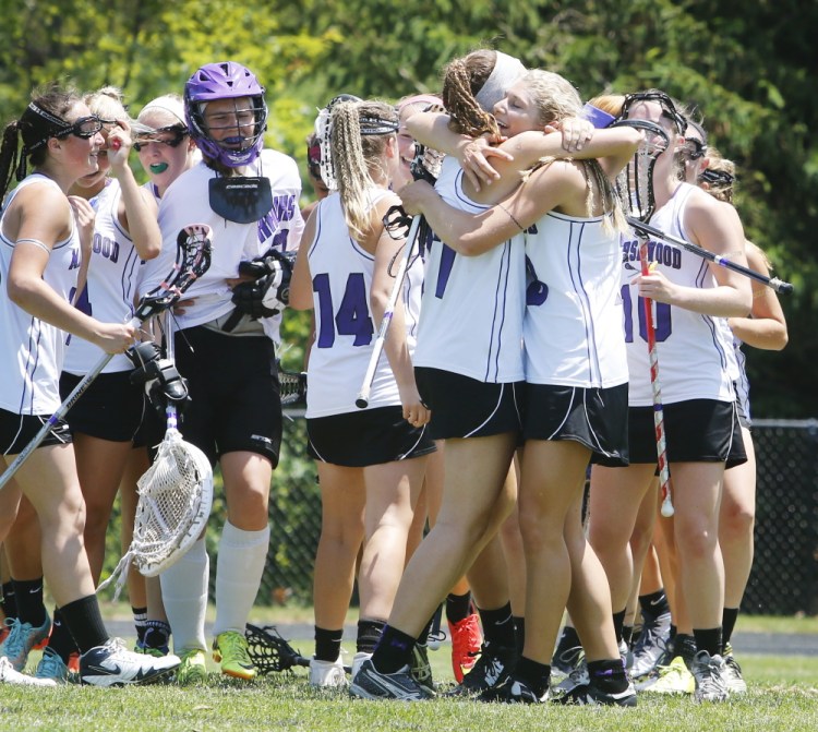 Marshwood’s Lindsey Poirier and Korinne Bohunsky embrace after the Hawks defeated Thornton Academy 4-2 Saturday to advance to the Western Class A girls’ lacrosse regional final.