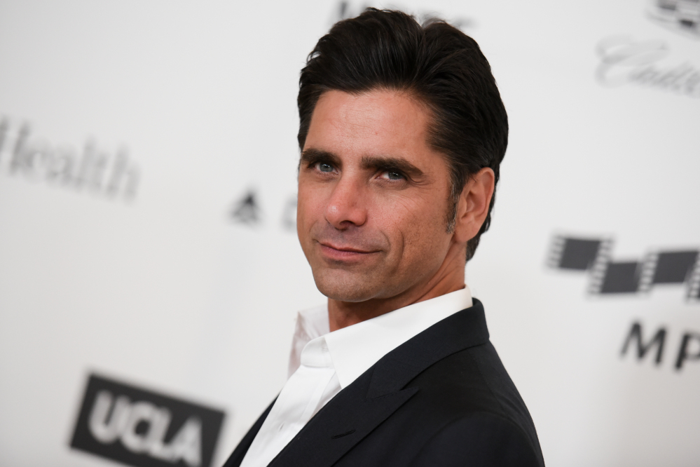 Actor John Stamos arrives at the 4th Annual Reel Stories, Real Lives Benefit in Los Angeles in April. Stamos was arrested and cited with driving under the influence in Beverly Hills. Police said they received calls around 7:45 p.m. Friday reporting a possible drunk driver. Police later stopped Stamos, who was the only person in the vehicle. Police said Stamos was taken to a hospital because of a possible medical condition.