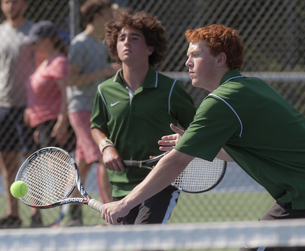 Peter Michalakes, left, and Stephen Epstein of Waynflete compete during Waynflete’s 4-1 victory against George Stevens Academy in the Class C boys’ tennis finals Saturday at Lewiston.