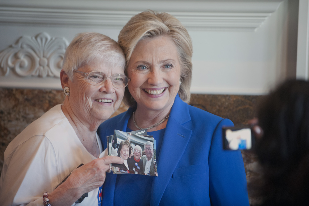 Anita Wendt of Sioux City, Iowa, poses for a photo with Democratic presidential hopeful Hillary Rodham Clinton during a campaign house party Saturday in Sioux City.