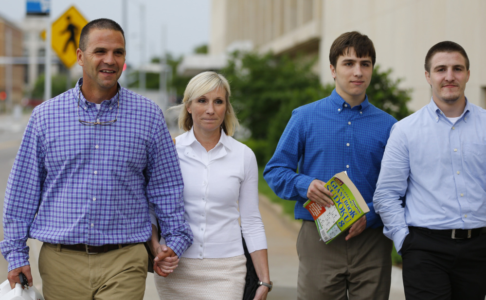 The suspect’s family, from left, parents Kyle and Melissa Durham, and brothers Josh and Zac Durham, leave federal court Monday in Oklahoma City.