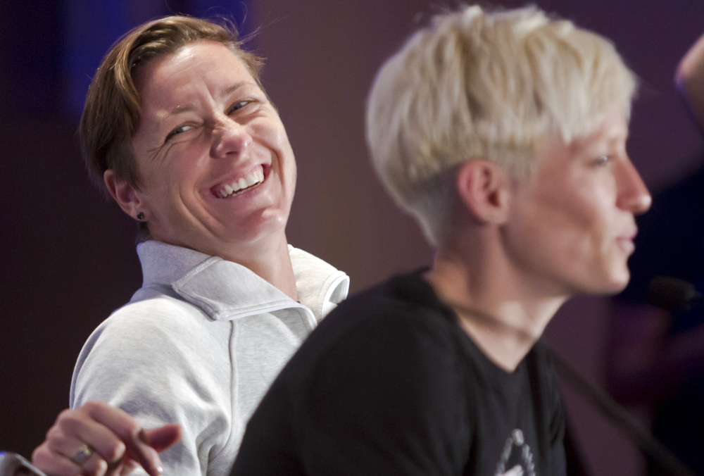 Abby Wambach, left, laughs as Megan Rapinoe speaks during the U.S. women’s soccer team World Cup media day in New York last month.
 AP file photo