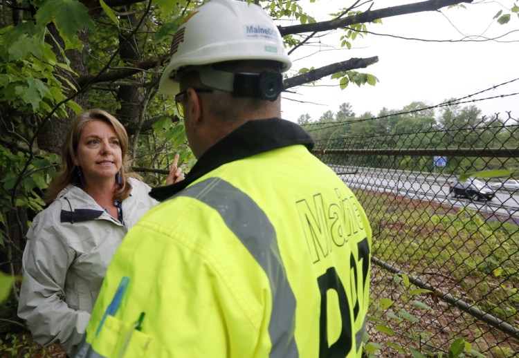Freeport resident Joni Tompson talks with a Maine DOT official near I-295.