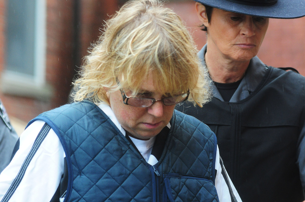 Joyce Mitchell heads into Plattsburgh City Court for a hearing on Monday in Plattsburgh, N.Y. Mitchell is charged with helping convicted murderers Richard Matt and David Sweat escape from Clinton Correctional Facility.