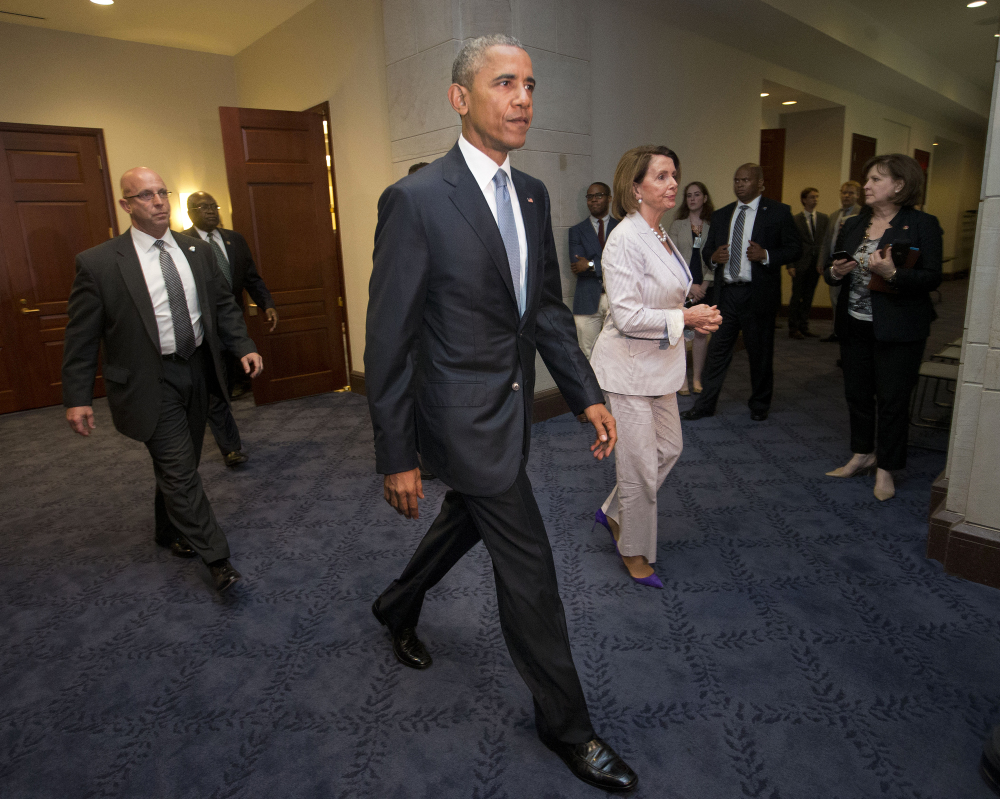President Barack Obama and House Minority Leader Nancy Pelosi of California leave a meeting Friday with House Democrats on Capitol Hill in Washington to discuss the global trade talks.