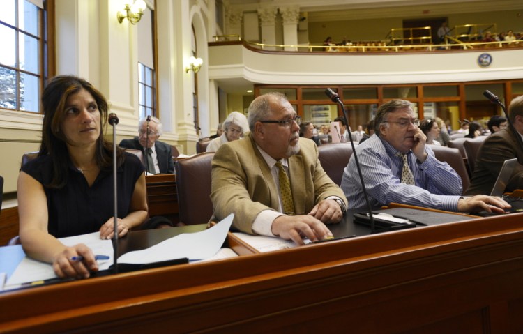 Left to right, Reps. Sara Gideon of Freeport, Mark Dion of Portland and Chuck Kruger of Thomaston vote during a House session Thursday on vetoes by Gov. Paul LePage.
Shawn Patrick Ouellette/Staff Photographer