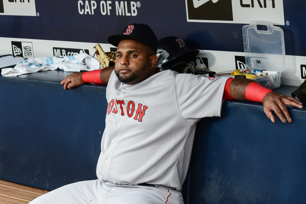 Boston Red Sox third baseman Pablo Sandoval sits on the bench before the start of Thursday night’s game against the Atlanta Braves. Manager John Farrell benched Sandoval because the players used his Instagram account during a loss to the Braves on Wednesday.