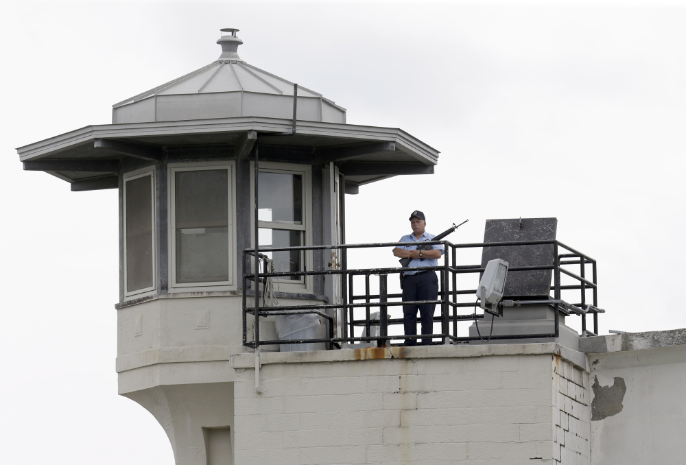 A prison employee stands guard on a tower at the Clinton Correctional Facility in Dannemora, N.Y., on June 10. Two men who escaped from the maximum-security prison June 6 are the subjects of a massive manhunt.