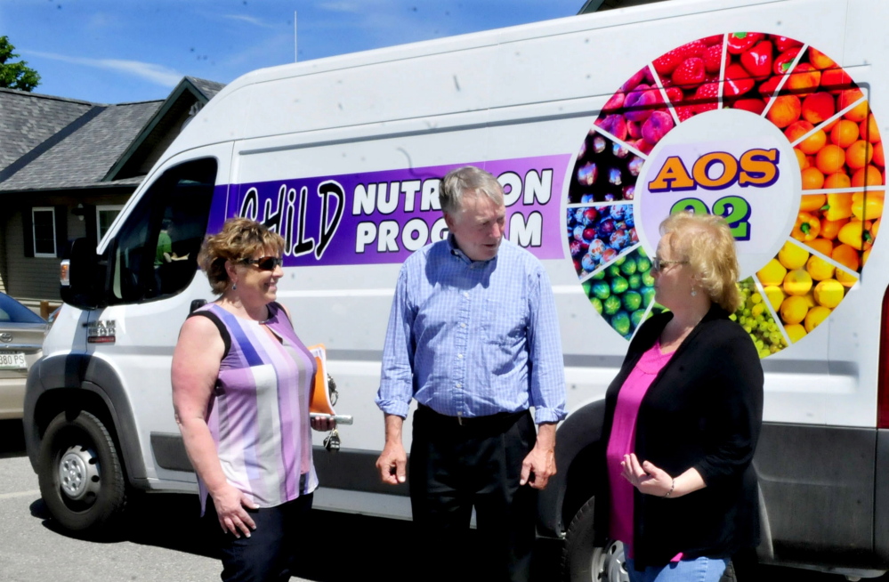Waterville school officials on Wednesday talk outside a new van that will be used in a food program this summer. From left are Alternative Organizational Structure 92 Finance and Food Director Paula Pooler, Superintendent Eric Haley and Food Services Supervisor Barbara Bonnell.
