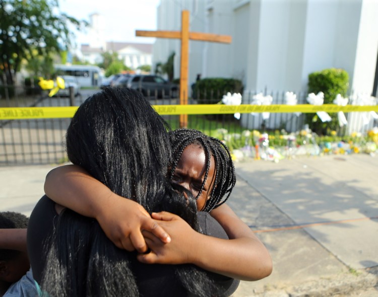 Kearston Farr hugs her 5-year-old daughter, Taliyah, as they visit a memorial for the nine shooting victims at the Emanuel AME Church in Charleston, S.C., on Friday.