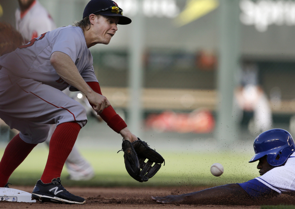 Lorenzo Cain of the Royals beats the tag by Red Sox shortstop Brock Holt for a stolen base in the first inning Saturday. Kansas City won, 7-4.