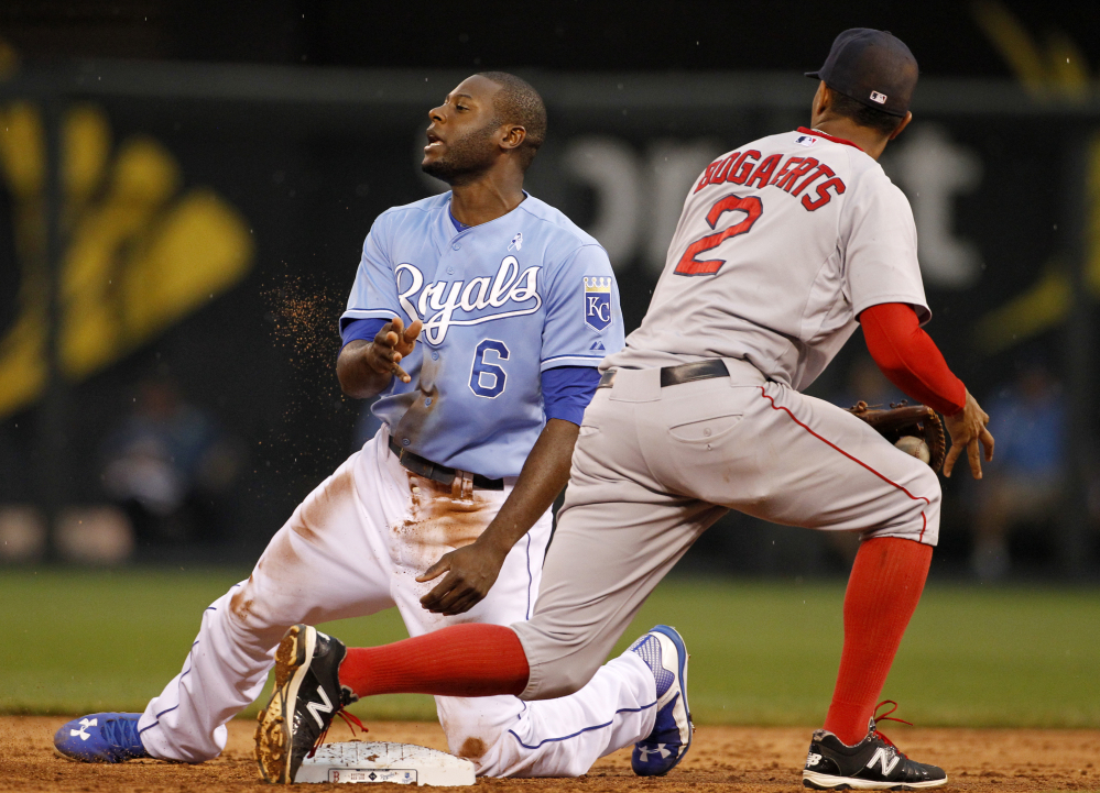 Kansas City Royals’ Lorenzo Cain reacts after getting tagged out by Boston Red Sox shortstop Xander Bogaerts while attempting to advance to second base on a bad pitch in the third inning Sunday at Kauffman Stadium in Kansas City, Mo.