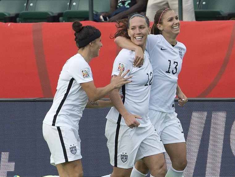 The United States’ Ali Krieger (11), Lauren Holiday (12) and Alex Morgan (13) celebrate a goal against Colombia in second half Monday in Edmonton, Alberta.