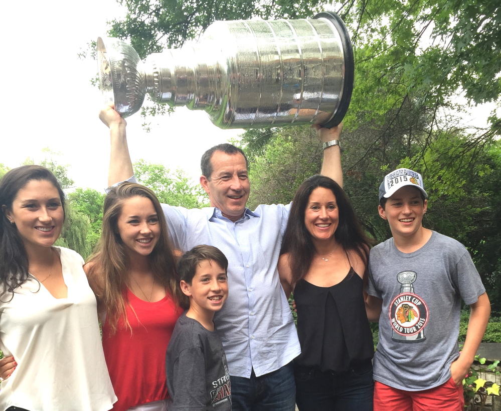 From left, Hannah, Emma, Declan, Kevin, Annie and William Dineen share a moment with the Stanley Cup in the backyard of Chicago Coach Joel Quenneville in Hinsdale, Ill., last week.