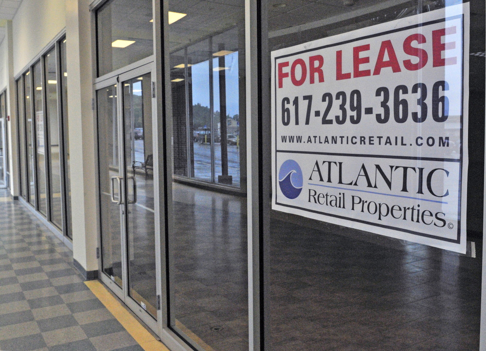 Signs advertising retail space for lease hang in the windows of several empty shops Tuesday at the Turnpike Mall in Augusta.