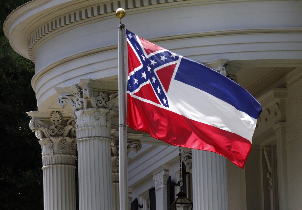 The state flag of Mississippi is unfurled against the front of the Governor’s Mansion in Jackson, Miss., Tuesday, June 23, 2015. Republican Lt. Gov. Tate Reeves said Tuesday, that Mississippi voters, not lawmakers, should decide whether to remove the Confederate battle emblem from the state flag.