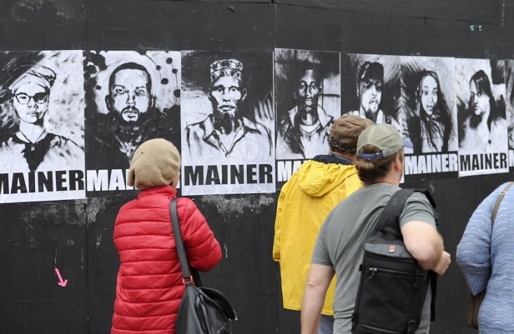 A group of eight portraits that first appeared in May on a black plywood wall next to Congress Street has become part of the citywide conversation about whether Portland should continue providing aid to asylum seekers. The black-and-white portraits show eight men and women of different ethnic backgrounds, each labeled “Mainer.” The portraits bear the signature of Pigeon, a street artist.