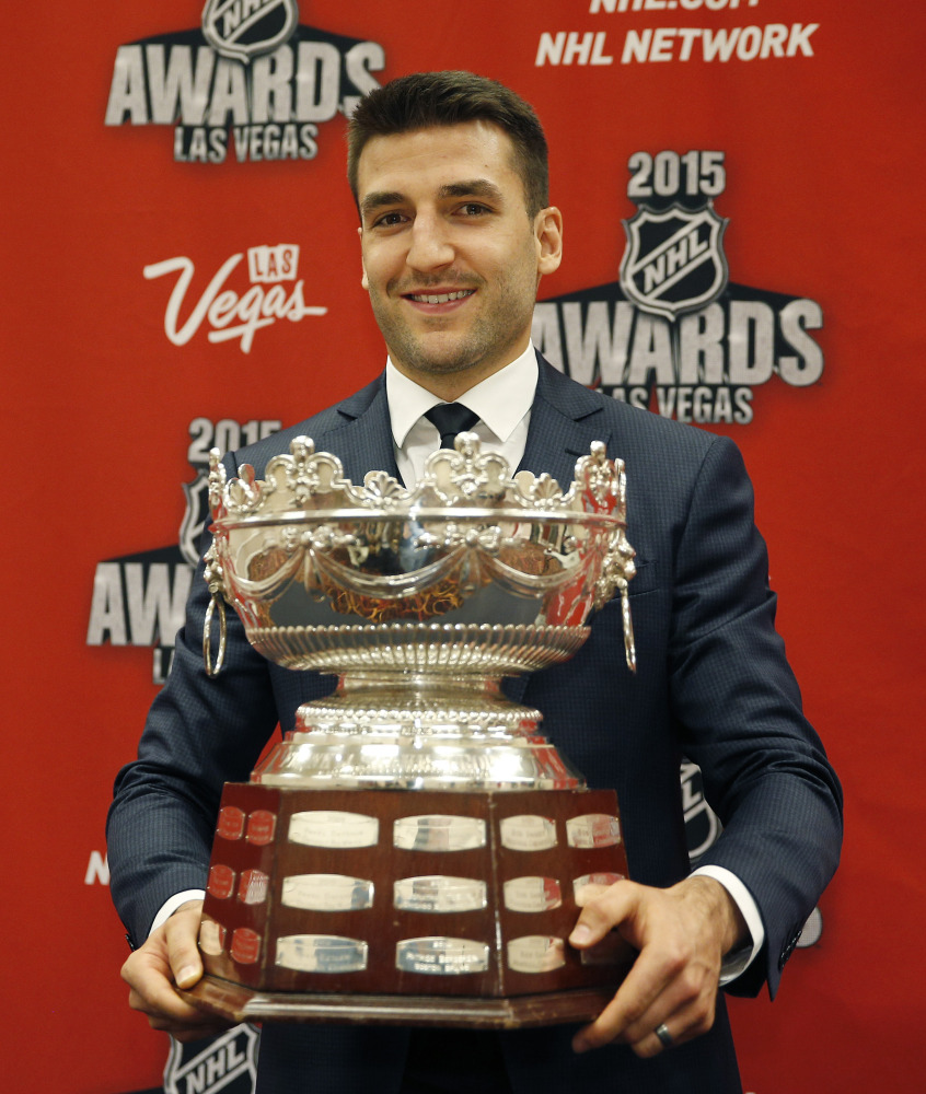 Patrice Bergeron of the Boston Bruins holds up the Frank J. Selke Trophy on Wednesday in Las Vegas. The Associated Press