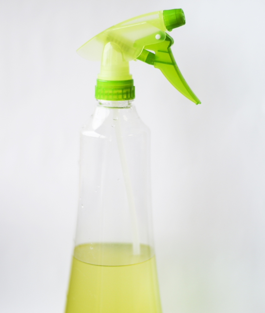Citrus-Rosemary Vinegar cleaner, strained and stored in a spray bottle.