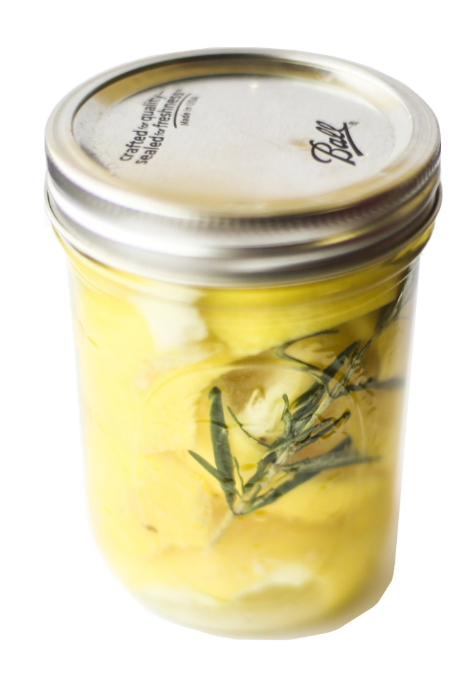 Citrus peel, vinegar and rosemary steep together in a Ball jar.