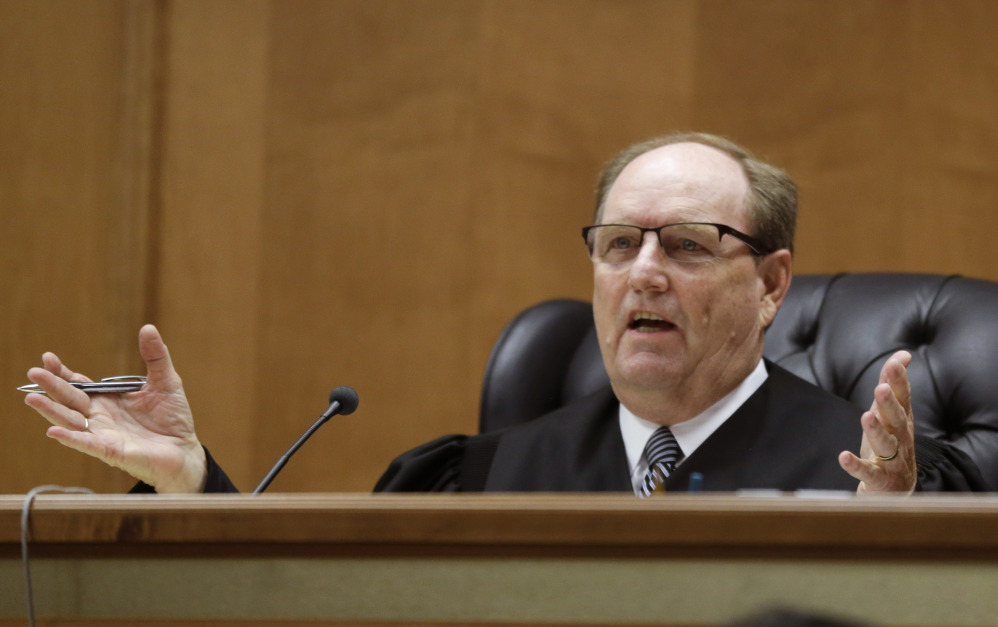 Judge Larry Hendricks asks a question of defense counsel during a hearing in Shawnee County District Court in Topeka, Kan., on Thursday. Hendricks blocked the state's first-in-the-nation ban on an abortion procedure that opponents refer to as "dismemberment abortion." The Associated Press