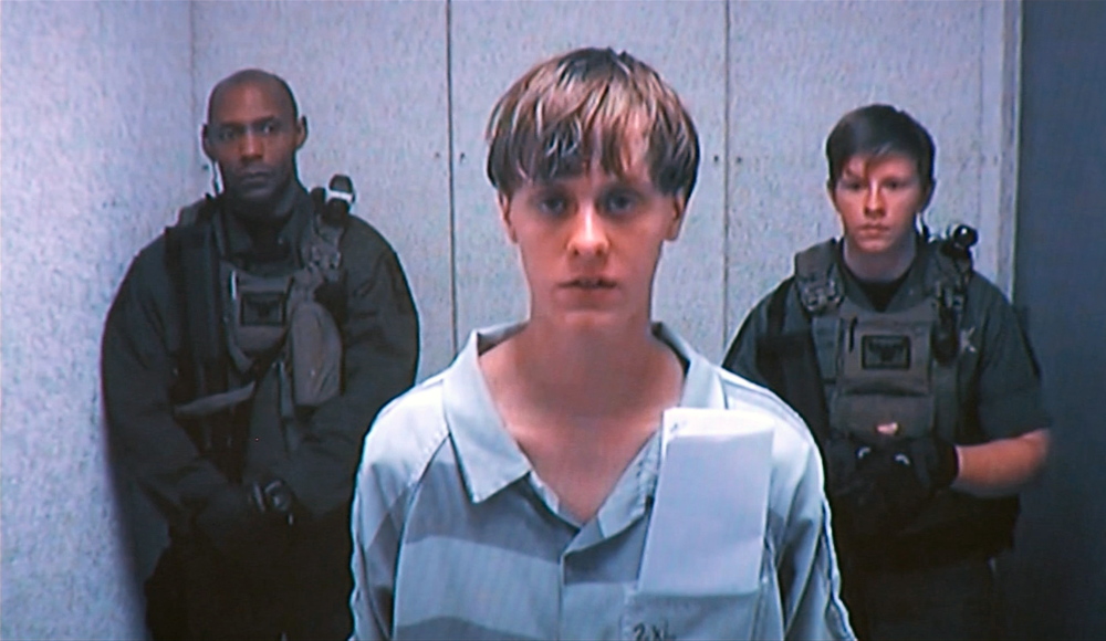 Dylann Roof appears by closed-circuit television at his bond hearing last Friday. The Associated Press