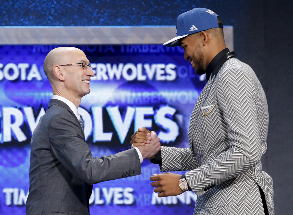 Karl-Anthony Towns, right, is greeted by NBA Commissioner Adam Silver after being announced as the top pick in the NBA draft Thursday night, taken by the Minnesota Timberwolves.
