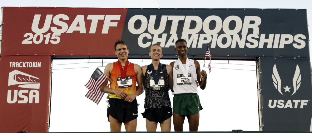 Runner-up Ben True, left, poses with winner Galen Rupp, center, and third-place finisher Hassan Mead after the 10,000 meters Thursday at the U.S. track and field championships.