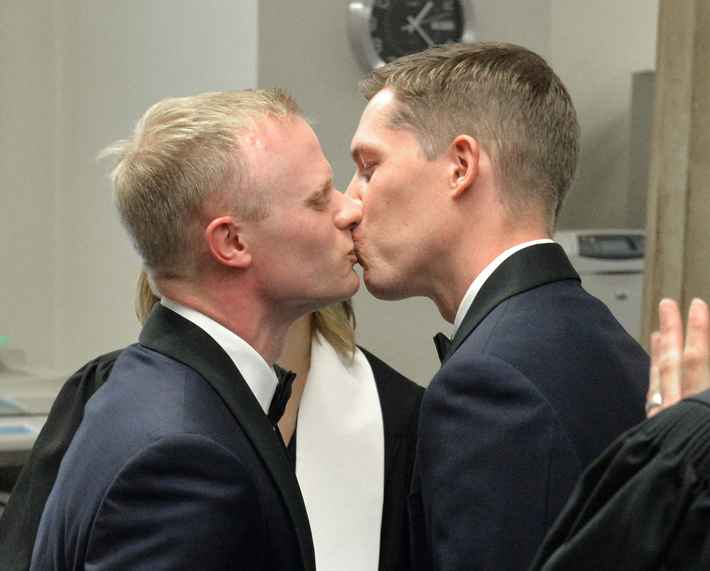 Benjamin Moore, left, and Tadd Roberts kiss after their marriage ceremony at the Jefferson County Clerks Office on Friday in Louisville, Ky.
The Associated Press