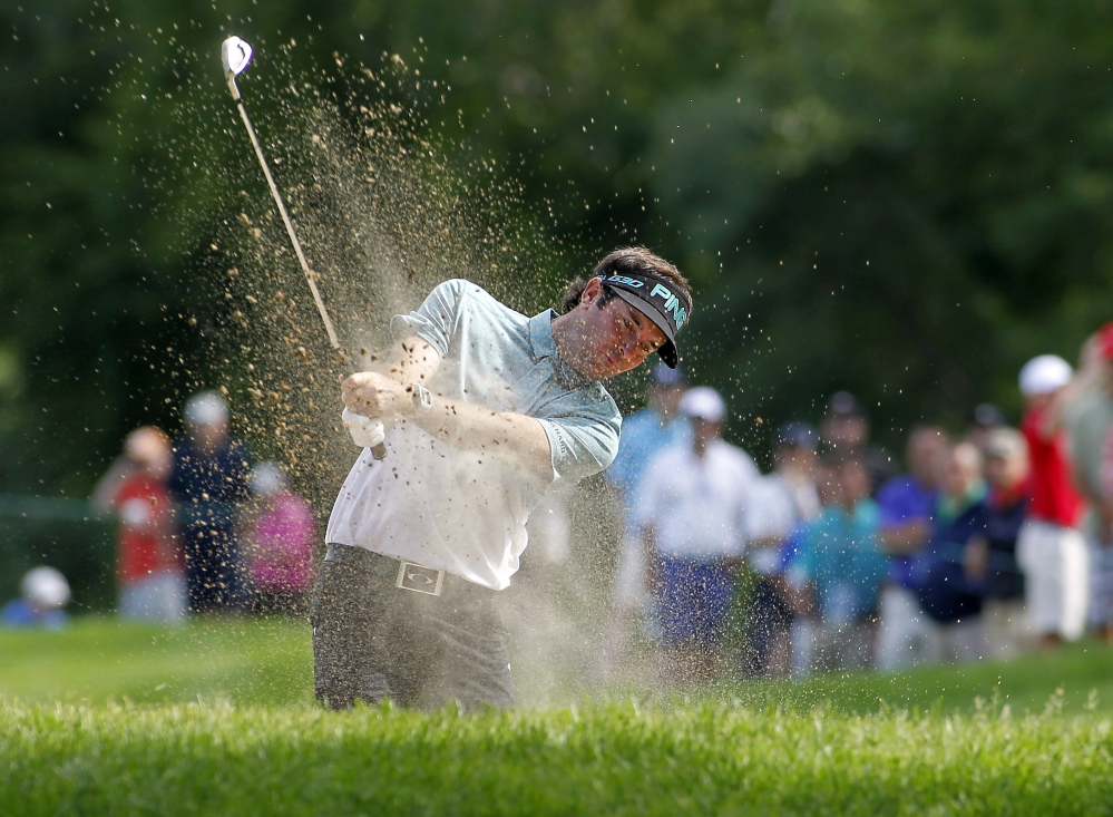 Bubba Watson hits out of a sand trap on the 13th hole during the second round of the Travelers Championship on Friday in Cromwell, Conn. Watson was at 11-under 129 through two rounds, holding a two-shot lead.