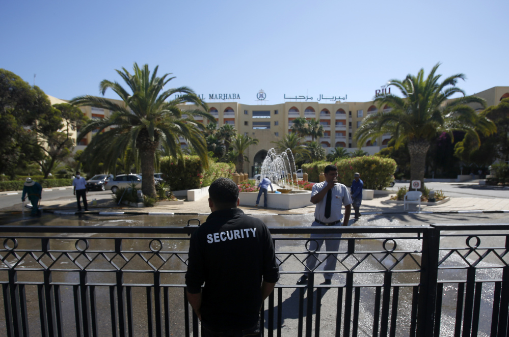 A security officer guards the entrance to the Imperial Marhaba hotel which was attacked on Friday in Sousse. The morning after a lone gunman killed dozens of people at a beach resort in Tunisia, busloads of tourists are heading to the nearby Enfidha-Hammamet airport hoping to return to their home countries.