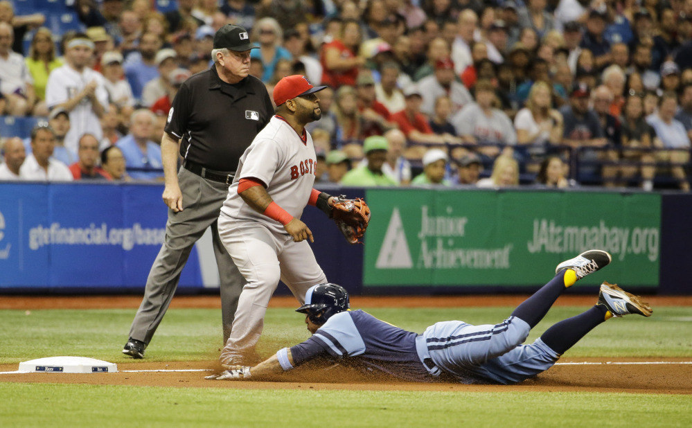 Tampa Bay Rays’ Asdrubal Cabrera slides into third on a triple, next to Boston Red Sox third baseman Pablo Sandoval in the fifth inning of a baseball game Saturday in St. Petersburg, Fla.