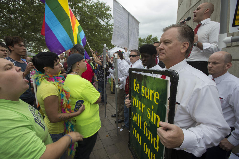 People protesting same-sex marriage picket at the Cincinnati Pride festival on Saturday in Cincinnati. While same-sex marriage is now protected, many states are without laws to prevent discrimination based on sexual orientation in other realms.