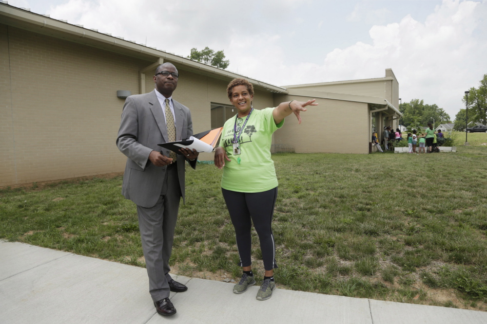 Jill Wilson, right, director of the community center, gave a tour to Emmanuel Caulk at William Wells Brown Elementary School in Lexington, Ky., on June 23. Caulk was hired Saturday night to lead the 40,000-student Lexington public school system.