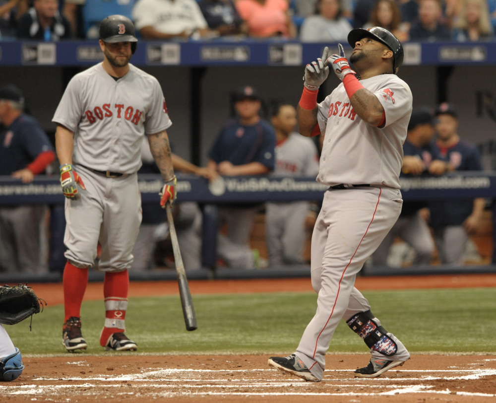 Boston Red Sox on-deck batter Mike Napoli, left, looks on as Pablo Sandoval scores after hitting a solo home run off Tampa Bay Rays starter Chris Archer in the second inning  Sunday in St. Petersburg, Fla.
